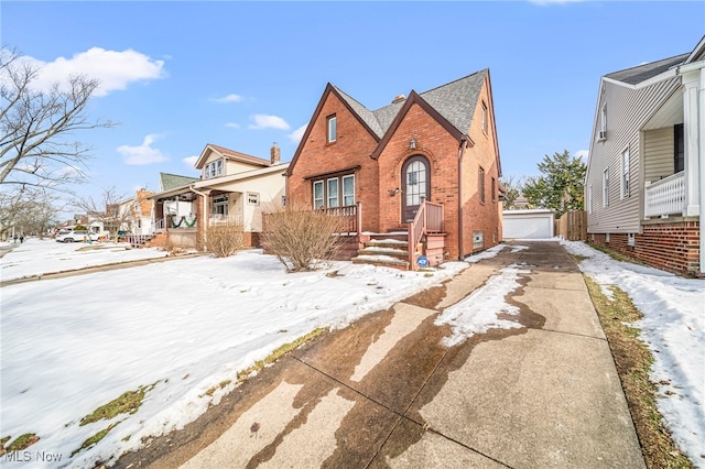 view of front of property with a garage and an outdoor structure