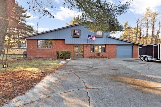 view of front of house featuring brick siding, a garage, and concrete driveway