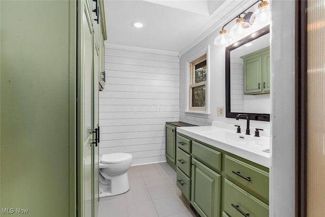 bathroom with wood walls, vanity, tile patterned floors, toilet, and ornamental molding