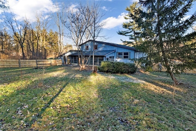 exterior space with fence and a yard