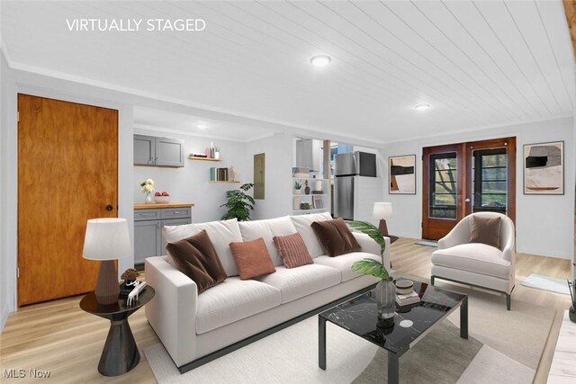 living area with french doors, ornamental molding, light wood-style flooring, and wood ceiling