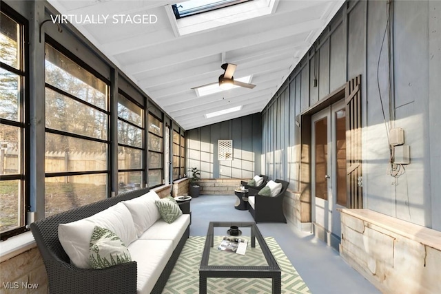sunroom featuring ceiling fan, an outdoor living space, and a skylight