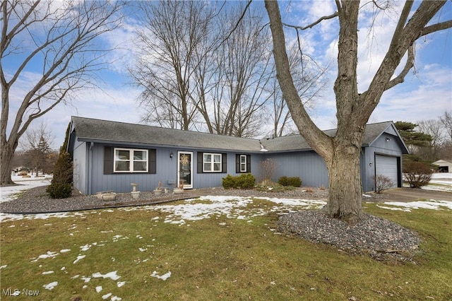 single story home featuring a garage and a front yard