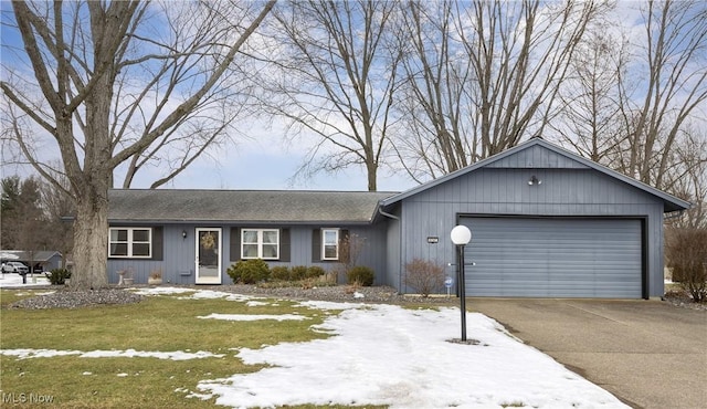 ranch-style house with a yard and a garage