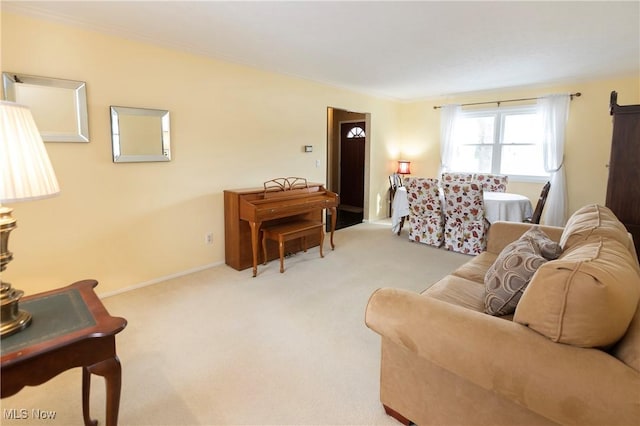 carpeted living room with ornamental molding