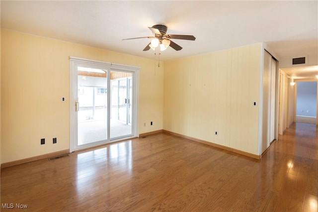 empty room featuring wood-type flooring and ceiling fan