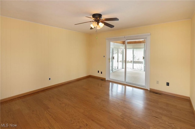 empty room featuring wood-type flooring and ceiling fan