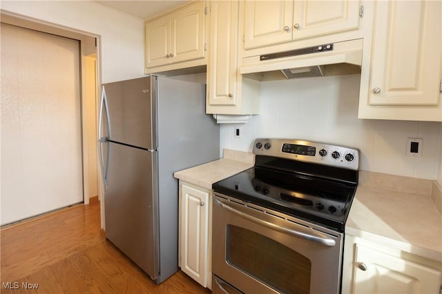 kitchen with stainless steel appliances and light hardwood / wood-style floors