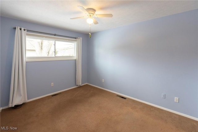 empty room featuring carpet flooring and ceiling fan