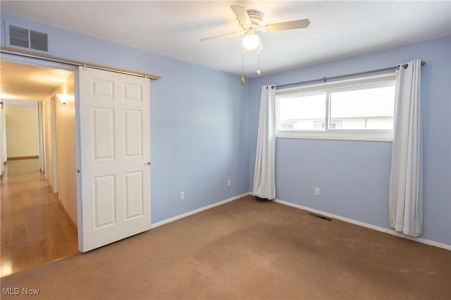 unfurnished bedroom featuring ceiling fan and carpet floors