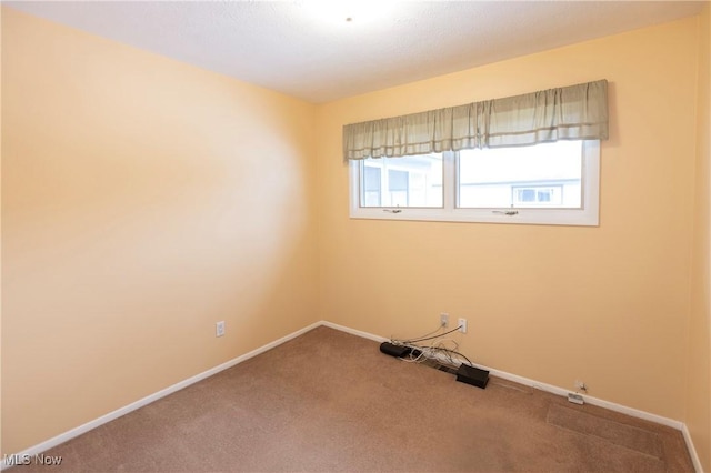 unfurnished room featuring carpet flooring