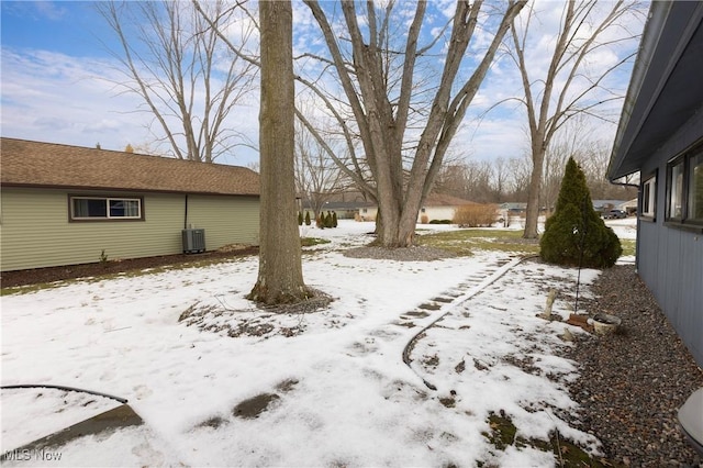 yard layered in snow with central air condition unit