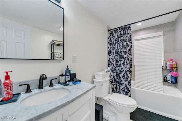 full bathroom featuring vanity, toilet, shower / tub combo, and a textured ceiling