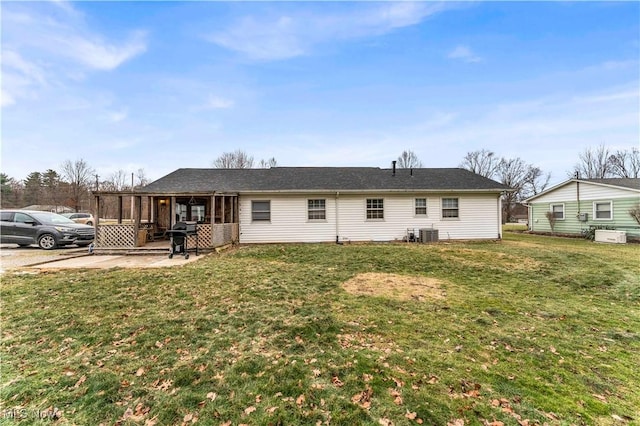 back of house featuring a patio, central AC, and a lawn