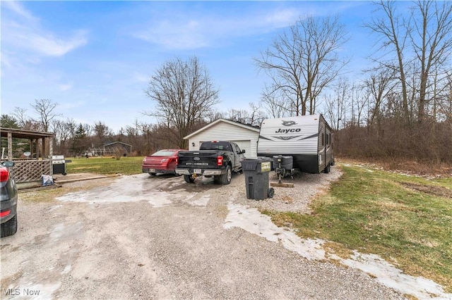 exterior space with a yard, an outdoor structure, and a garage