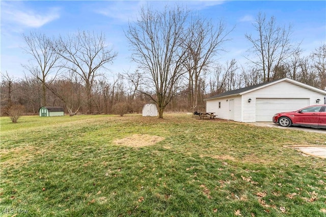 view of yard with a garage and a storage shed