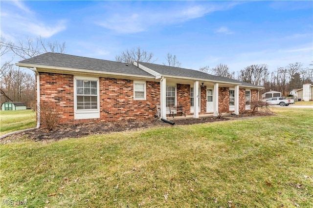 view of front of property featuring covered porch and a front yard