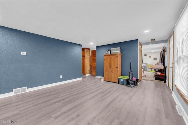 unfurnished living room with light wood-type flooring