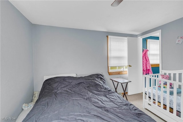 carpeted bedroom featuring ceiling fan