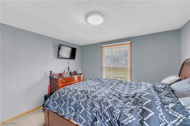 bedroom with carpet and a textured ceiling