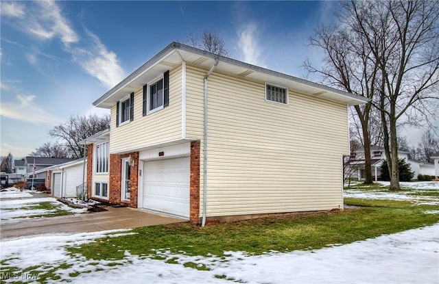 snow covered property with a garage