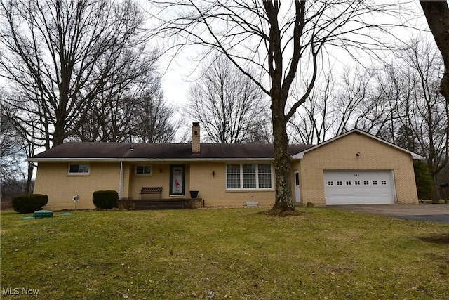 ranch-style home featuring a garage and a front lawn