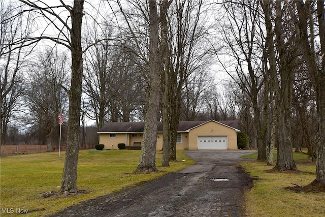 view of front of house featuring a garage and a front lawn