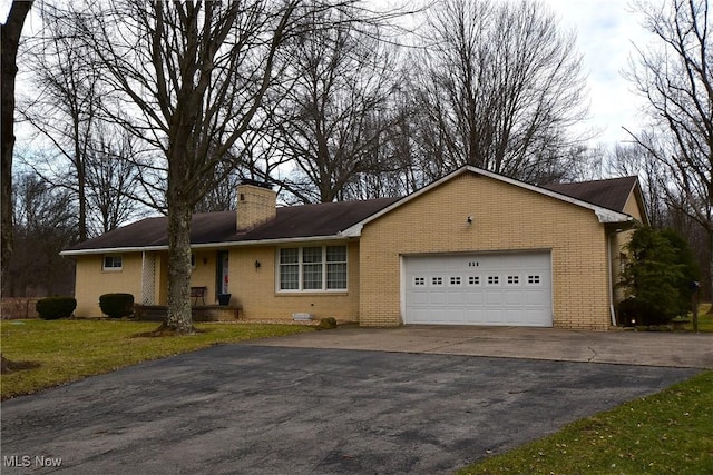 ranch-style home with a garage and a front yard