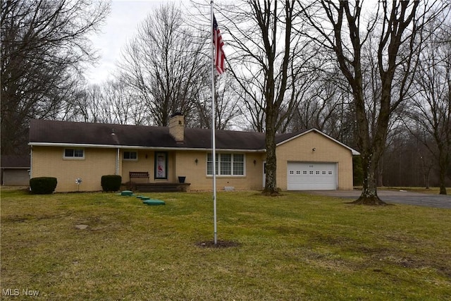 ranch-style home with a garage and a front lawn