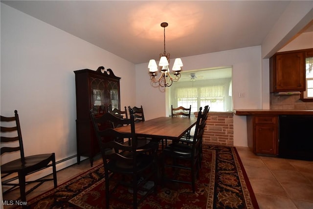 dining room featuring an inviting chandelier, a baseboard radiator, and tile patterned floors