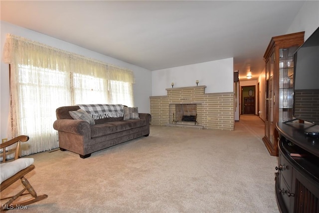 living room featuring a brick fireplace and light carpet