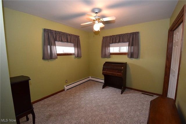 carpeted bedroom with baseboard heating, ceiling fan, and multiple windows