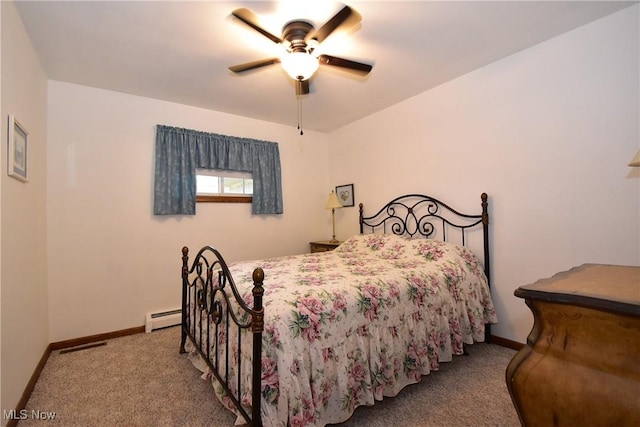 carpeted bedroom featuring baseboard heating and ceiling fan