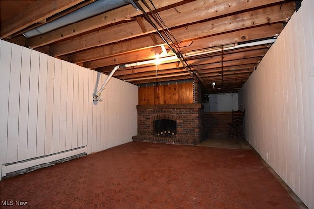 basement with baseboard heating and a fireplace