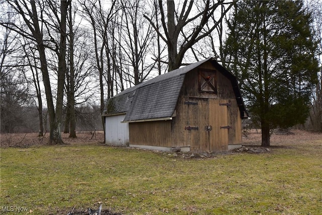 view of outbuilding featuring a yard