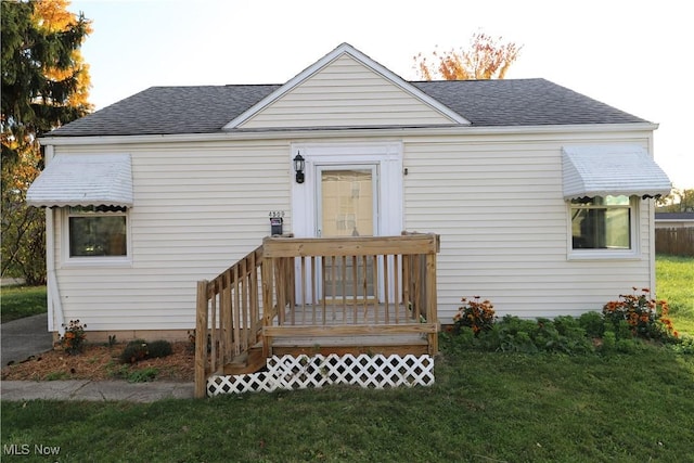 rear view of property with a yard