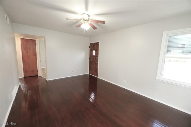 spare room with ceiling fan and dark hardwood / wood-style flooring