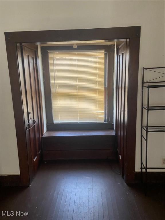 unfurnished room featuring dark wood-style floors