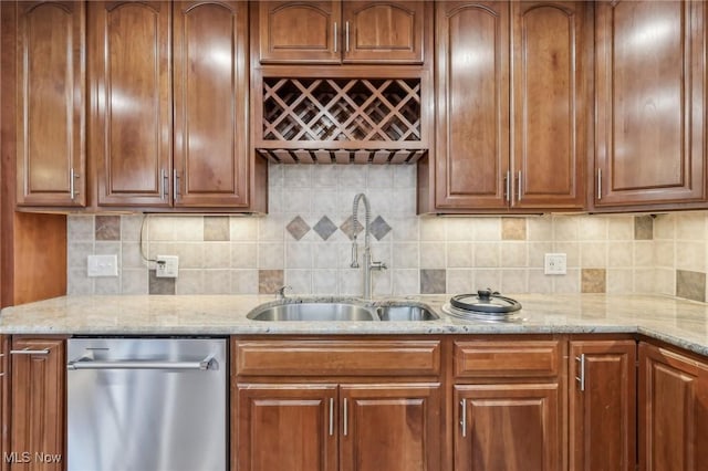 kitchen with dishwasher, sink, light stone countertops, and backsplash