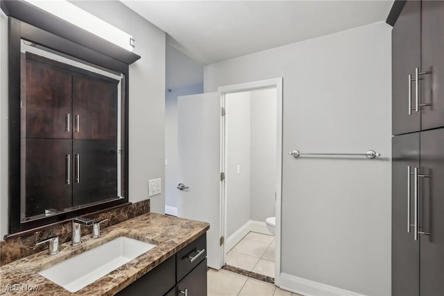 bathroom with vanity, tile patterned floors, and toilet