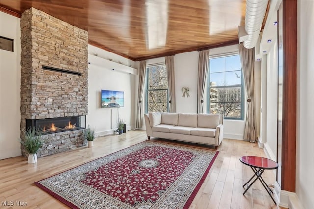 living room with wood ceiling, a fireplace, and light wood-type flooring