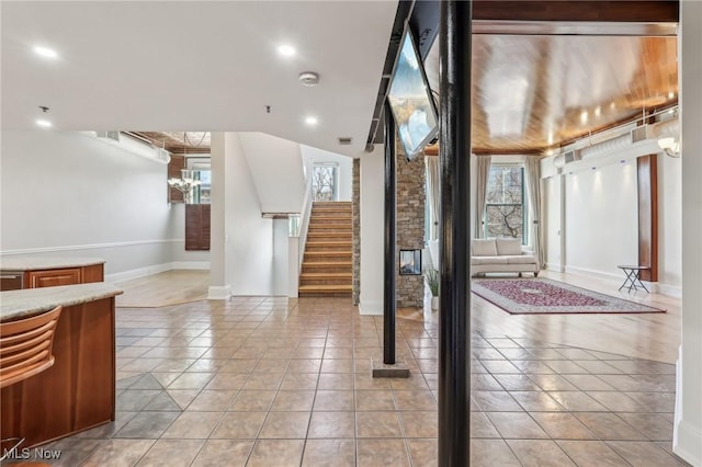 tiled entrance foyer featuring lofted ceiling and a healthy amount of sunlight