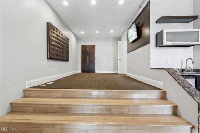 staircase featuring sink