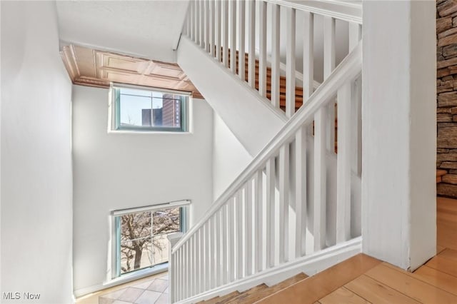 staircase with hardwood / wood-style floors