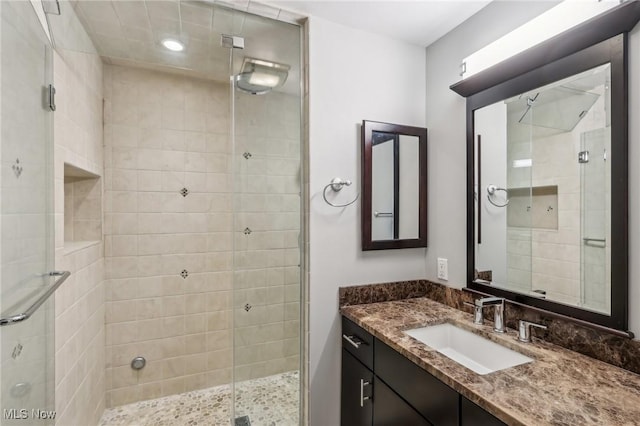 bathroom with walk in shower and vanity