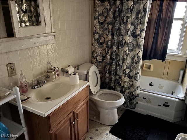 full bathroom with toilet, tile walls, shower / bath combination with curtain, vanity, and decorative backsplash