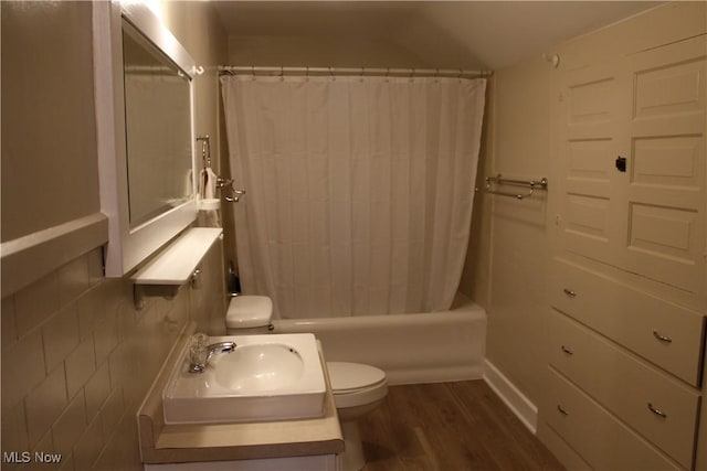 full bathroom with shower / tub combo, toilet, sink, and hardwood / wood-style floors