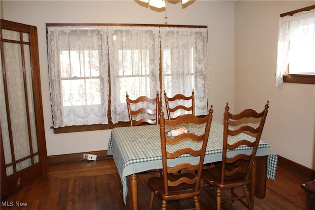 dining area with dark hardwood / wood-style flooring