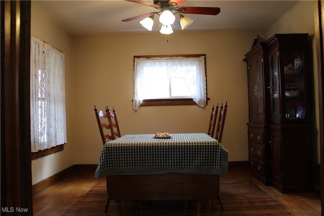 dining space with dark hardwood / wood-style flooring and ceiling fan