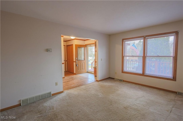 empty room with light colored carpet